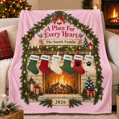 Personalized blanket custom family name in pink with six stockings, draped over a sofa by a Christmas tree