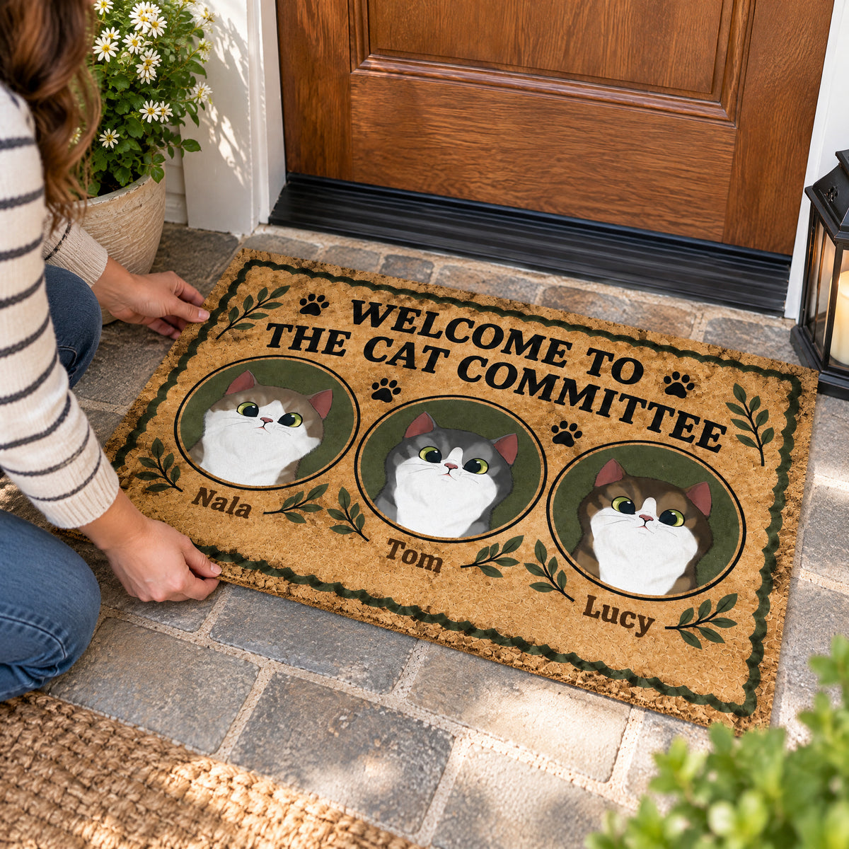 Personalized Cat Committee Doormat with three cat portraits being set down on stone steps by a person kneeling