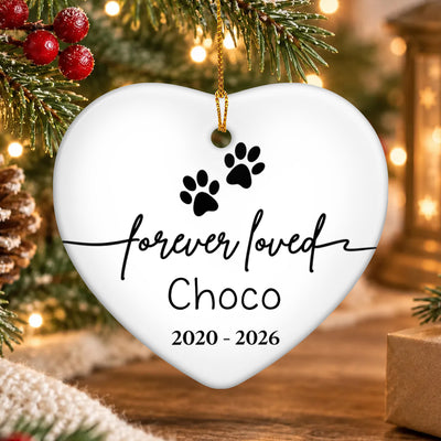 Forever Loved Personalized Ceramic Ornament heart with paw prints and Choco, hanging by pine branch and lights