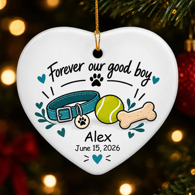 Personalized ceramic ornament Forever Our Good Boy heart with collar, ball and bone hanging on a lit tree