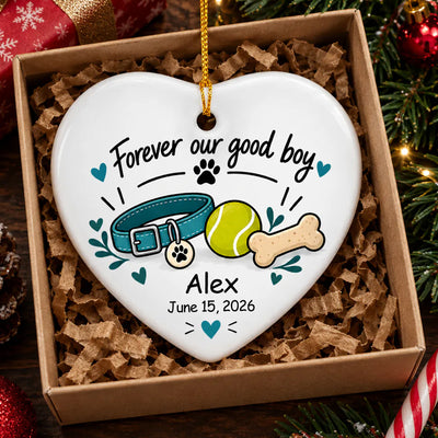 Personalized ceramic ornament Forever Our Good Boy heart resting in a kraft gift box with paper shred filling