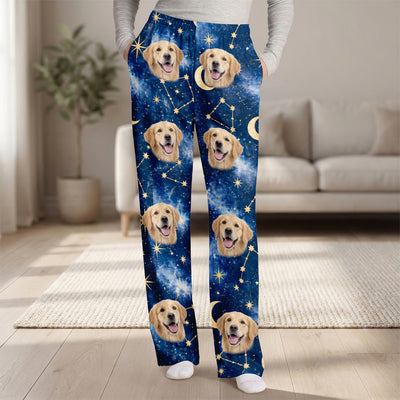 Custom pet photo personalized pajama pants with golden retriever faces, worn in front of a sofa in a living room